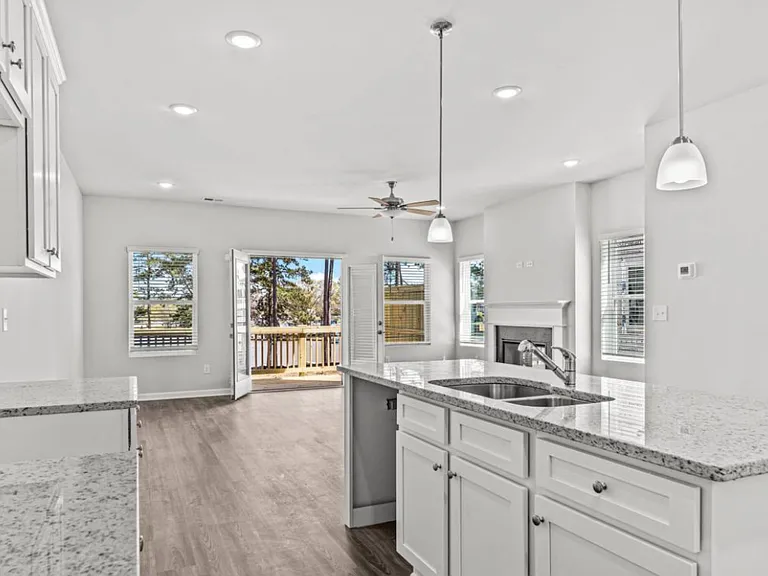 Kitchen with island, granite counters, picture taken before stainless appliances installed (May 2025)