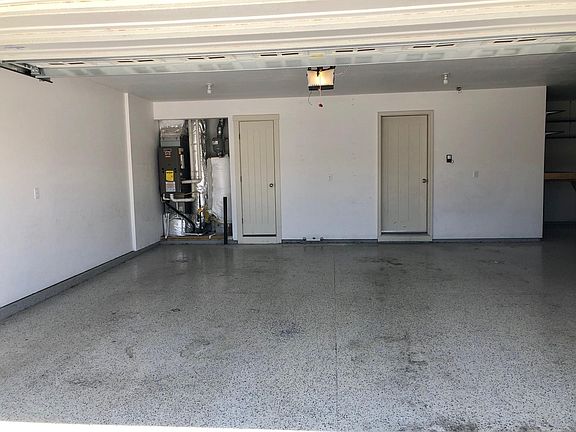 larger bay of the garage, can easily hold 2 cars with storage space for your toys and tools in third bay.