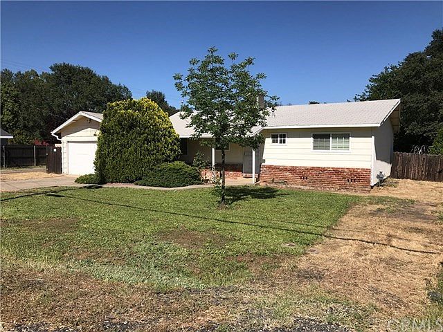 Front view shows ample parking and possible RV parking on right