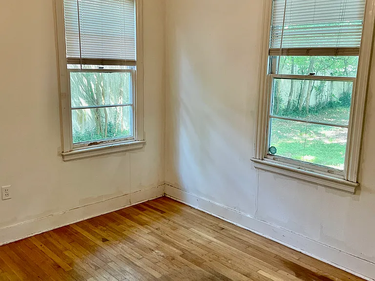 Rear bedroom with hardwood floors and closet.
