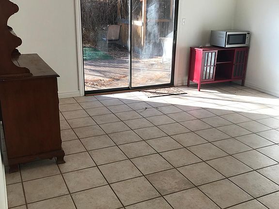 Dining area with cabinets and console table (microwave not included). Sliding doors leading to back yard