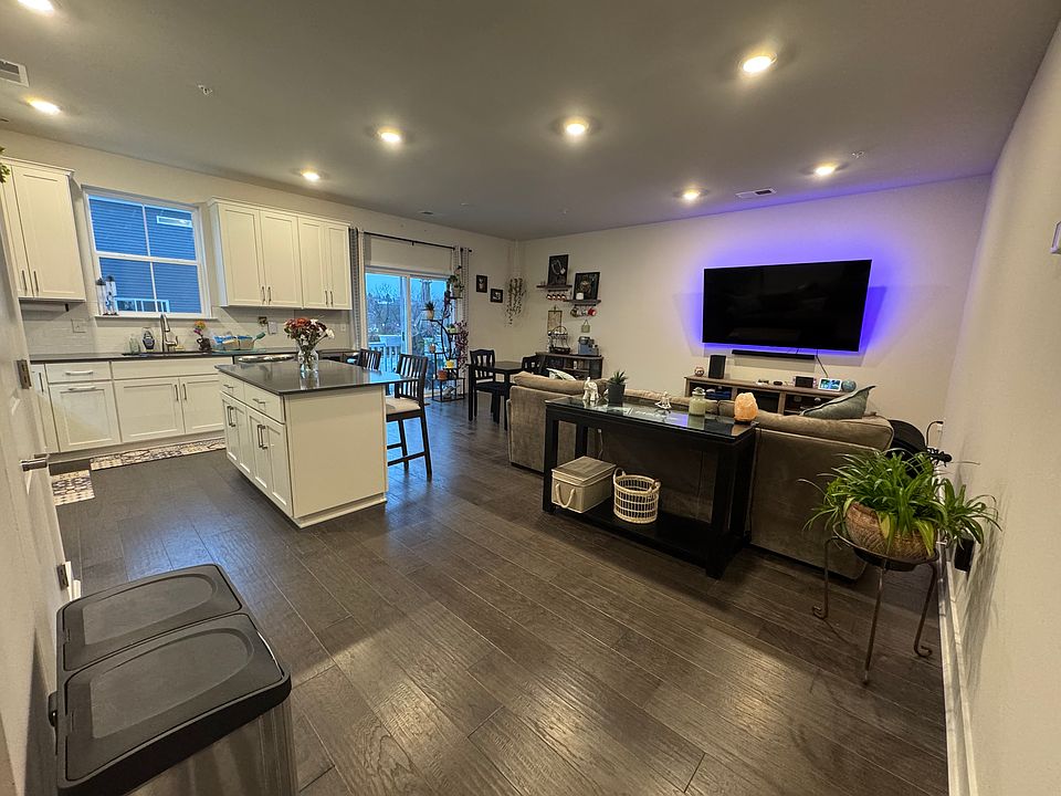 Kitchen, living, and dining area on second floor. Dining area opens to south-facing balcony
