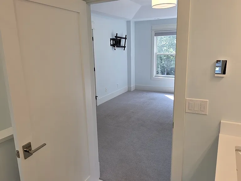 Photo from primary bathroom looking into primary bedroom.