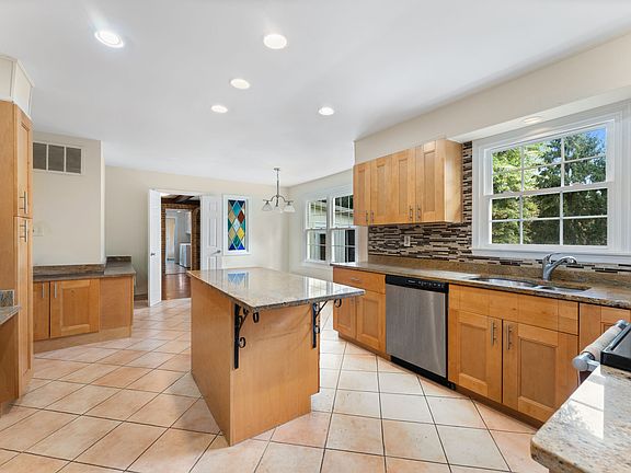 Kitchen island surrounded by 42" maple cabinetry!