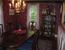 formal dining with original antique beams and wide pine flooring