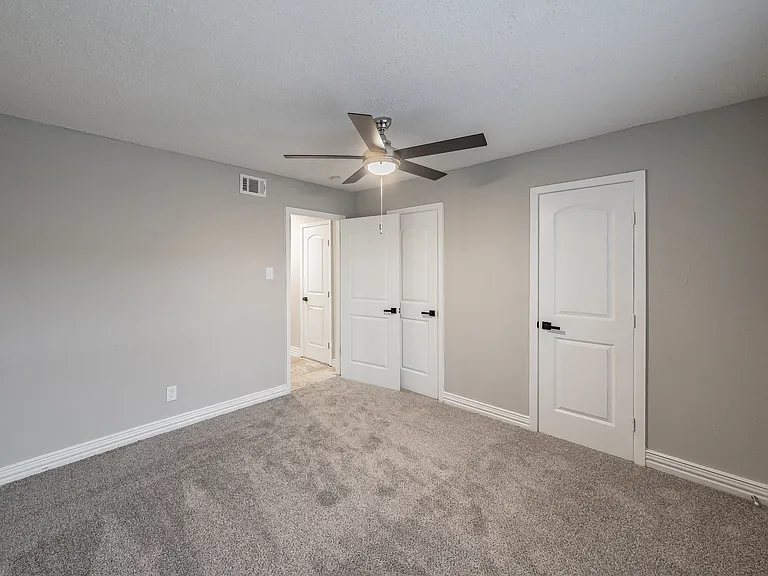 Comfortable bedroom with natural light and ample closet space.