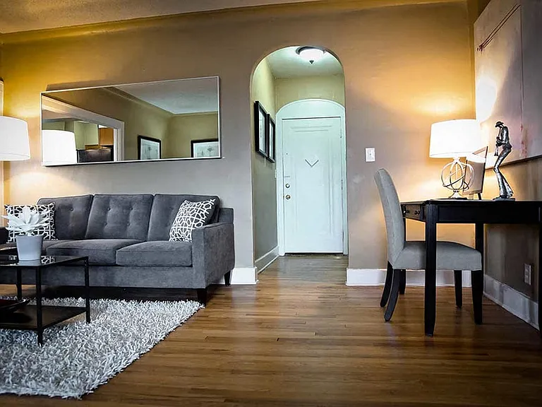 Living room with arched doorway.