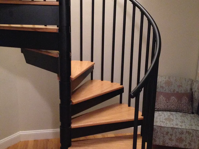 Beautiful spiral staircase leads to lower level master suite. There is a small area at bottom of stairs that can be used as home office or sitting area.