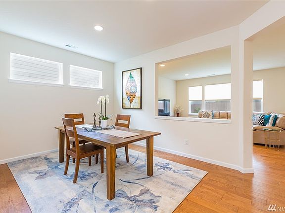 Spacious Dining Room Light & Bright with Windows & Can Lights - Open to Living Room with Plenty of Room for Hutch or Buffet.