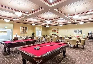Community Room with kitchen, fireplace, pool tables, and entertainment room