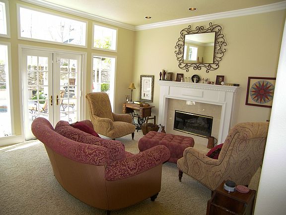 Formal living room with elegant fireplace and french doors