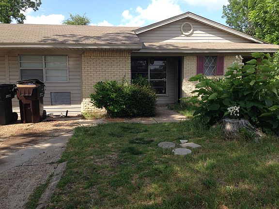 Front of house, before they cut grass & bushes