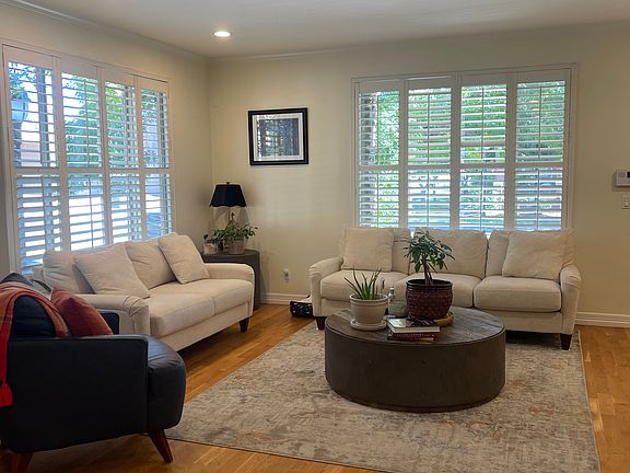 Large front living room with entry doors to front and side of house.