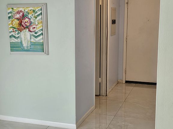 Master bedroom with view of wall safe and front door.