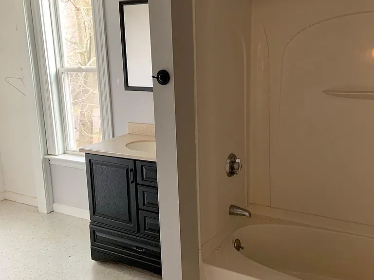 Large 2nd floor bathroom with bath and shower and built in shelving/ drawers not seen in photo