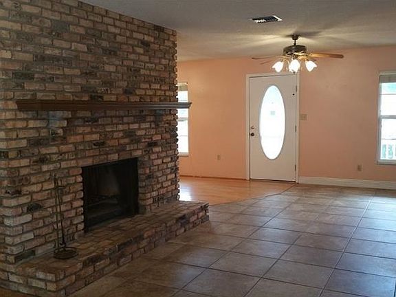 Living Room with Brick, Wood-Burning Fireplace