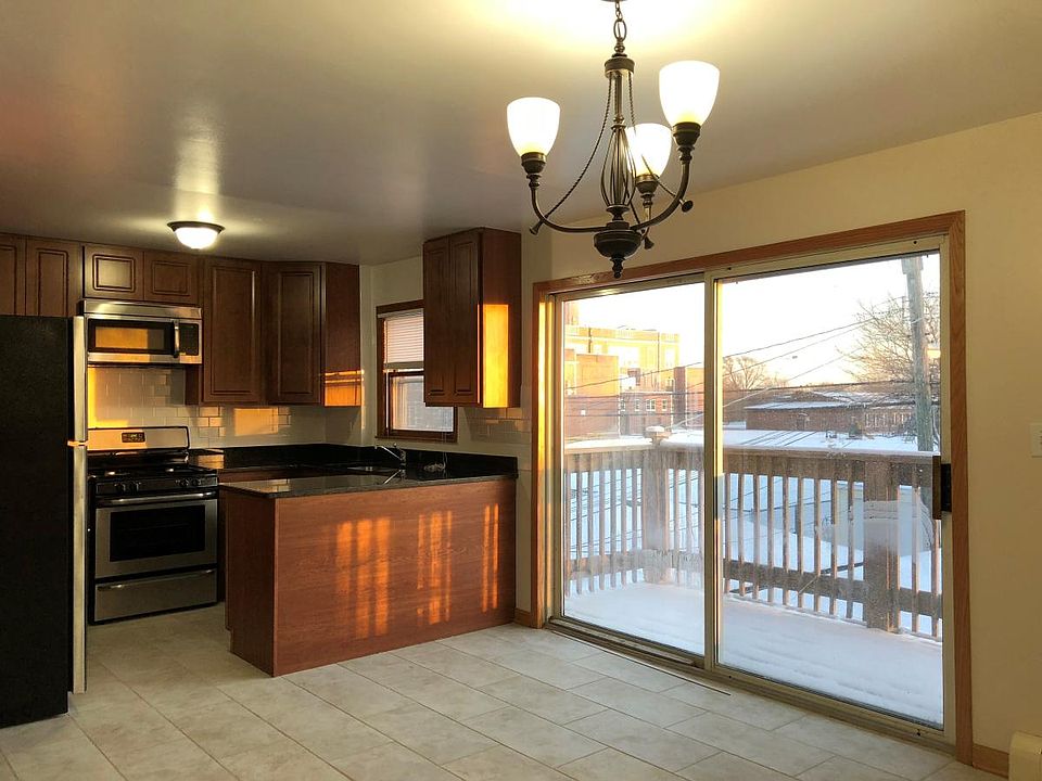 Kitchen leads to private balcony and family room.