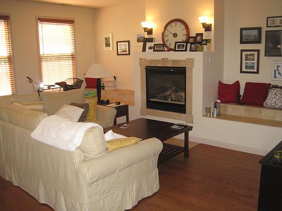 Sunny Living Room with gas fireplace, dimming lights and built-in seating.