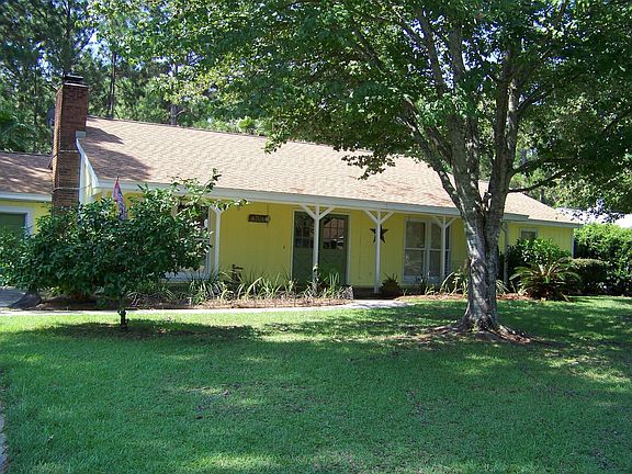 Newly repainted exterior with large silver maple and lemon
