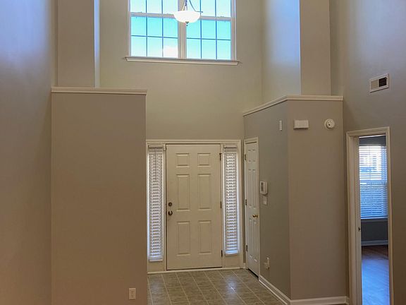 Entry with Vaulted ceiling that with master bedroom off to the right and part of living area.