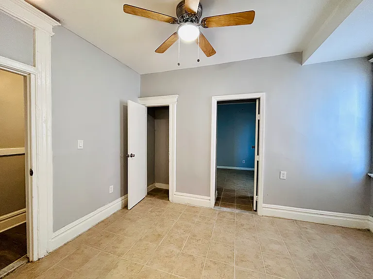 Living Room with closet & window. Access to a full bathroom, bedroom 3, and a half bathroom next to this room