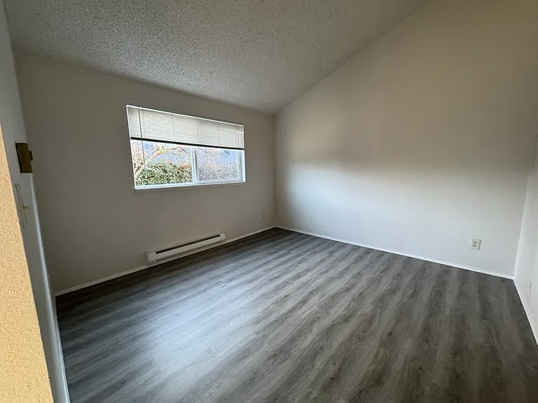 Bedroom with large window, new LVP floor