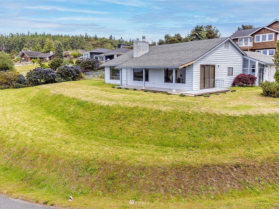 Perched on a large, corner lot to afford the best views of the water.