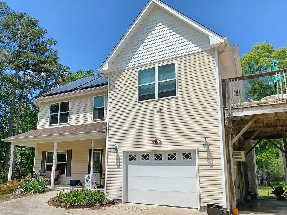 Front of house. Note deck which is off the Master Suite on the 2nd FL with parking below it.