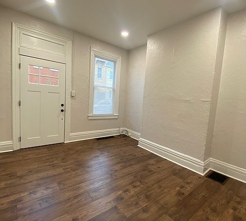 Freshly painted living room with new lighting and flooring