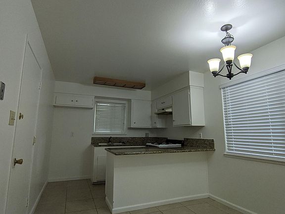 Kitchen and dining room. Door to garage.