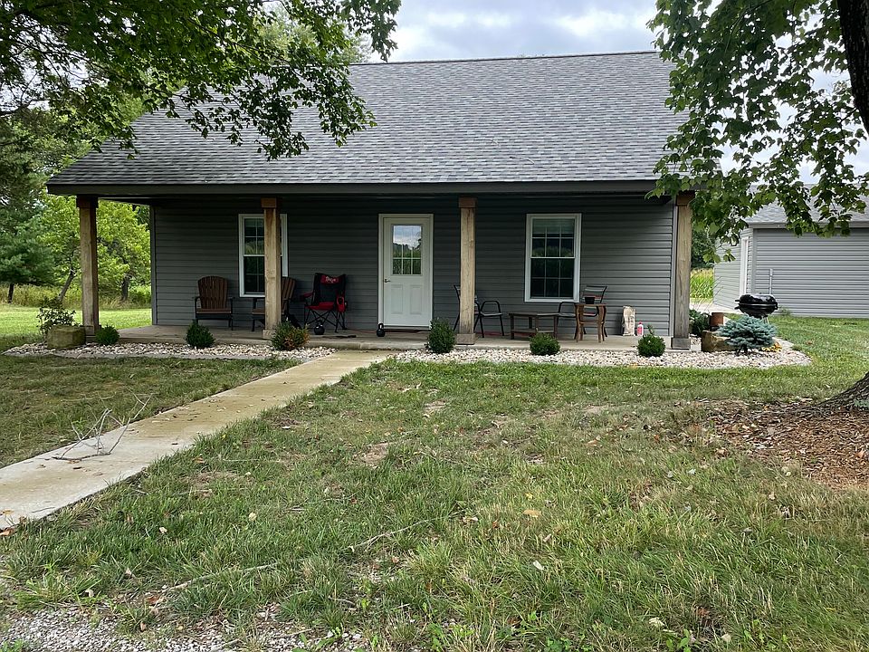 Front side picture. The house faces south looking toward a field.