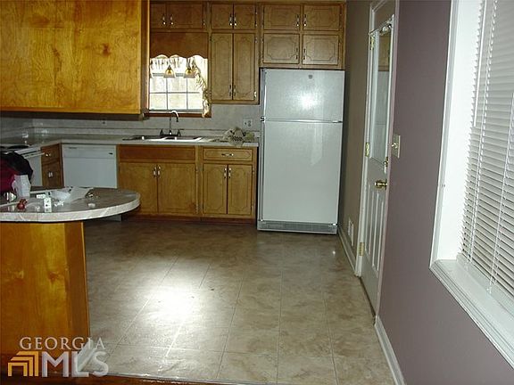 Kitchen from Livingroom. Carport Entry. Lots of Cabinets.