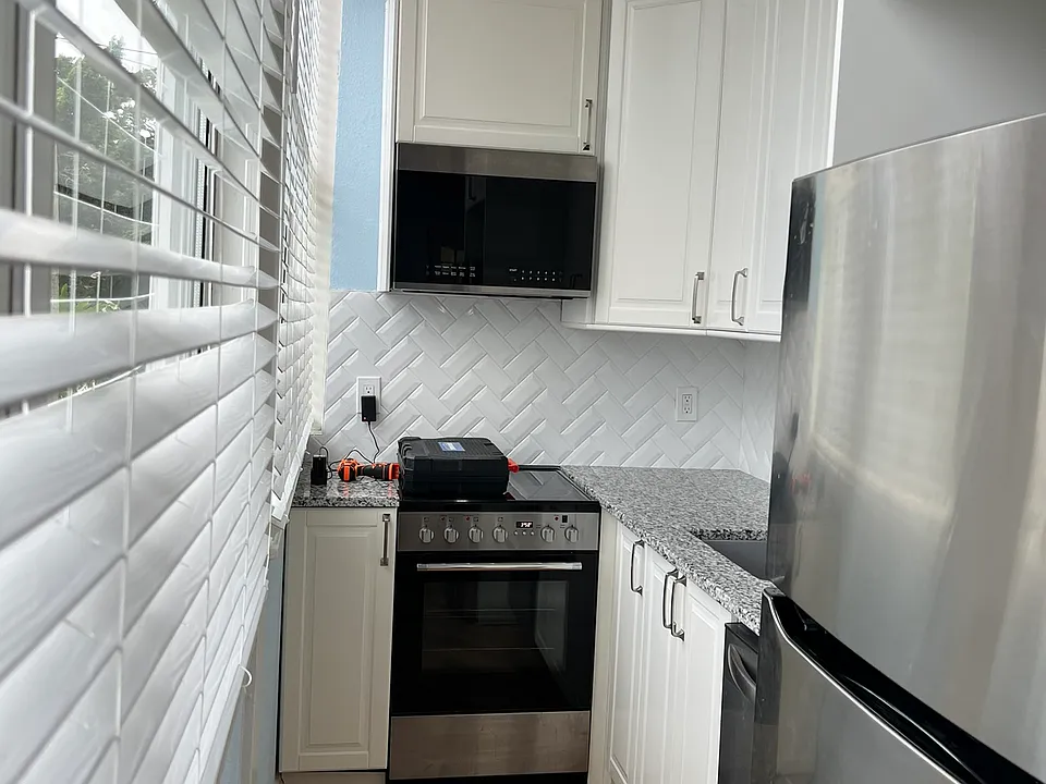 Kitchen has tall ceiling and wonderful big windows with views of the bay