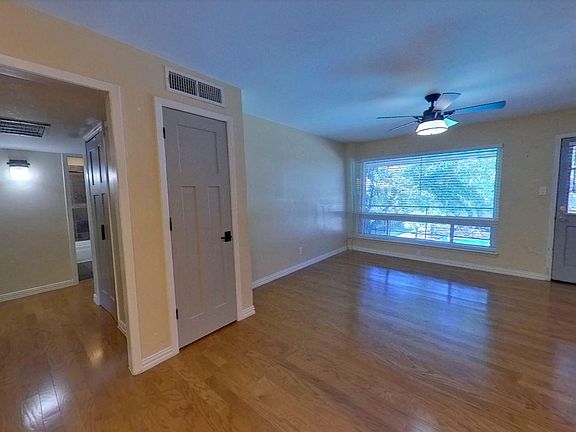 Front door, living room, and hallway to bedrooms. Laundry closet is in hallway.