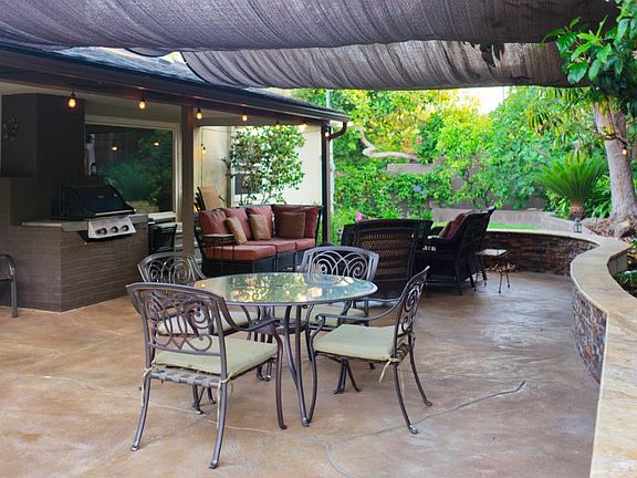 Shaded furnished patio with built in gas BBQ grill