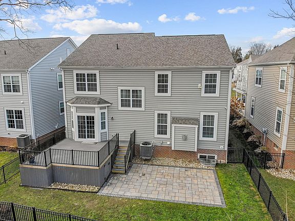 Custom composite deck and custom patio with fenced yard.