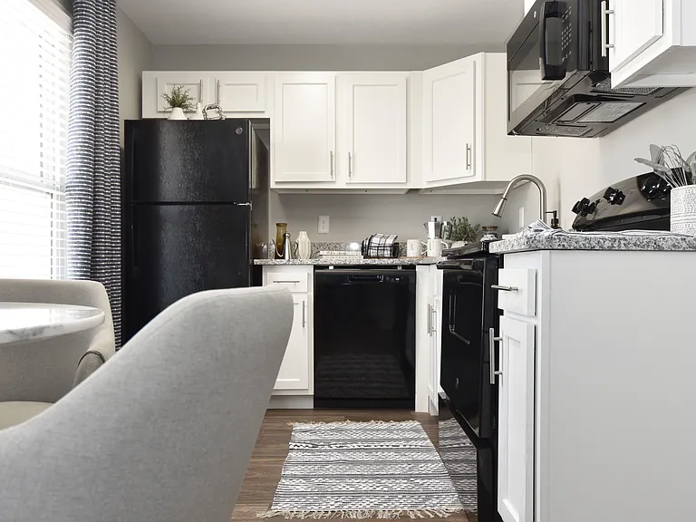 Kitchen with granite counters and black appliance package