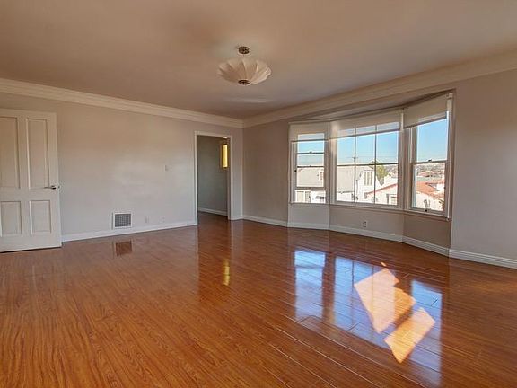 Spacious living room with lots of windows.