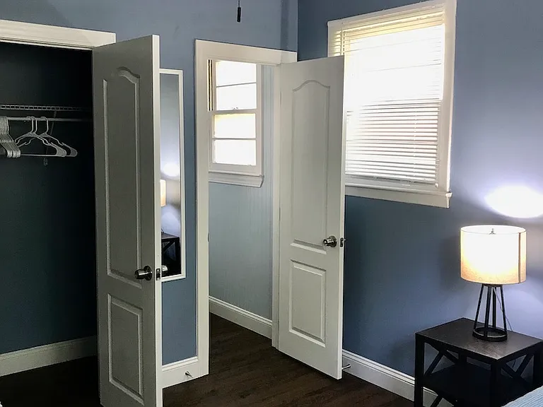 Bedroom with queen bed & half bath