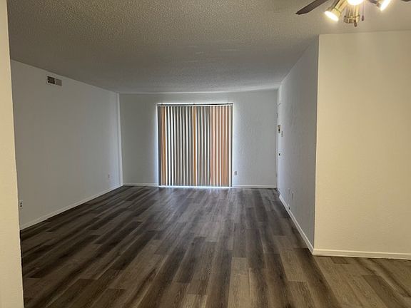 Living room with luxury vinyl plank flooring view from kitchen