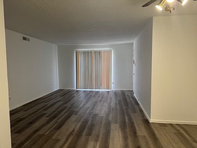 Living room with luxury vinyl plank flooring view from kitchen