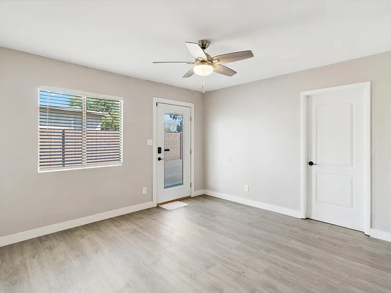 Large living room with all fresh paint, ceiling fans, doors, hardware and more!