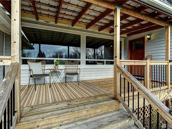 This covered front porch provides plenty of space to sit back, relax and enjoy the area