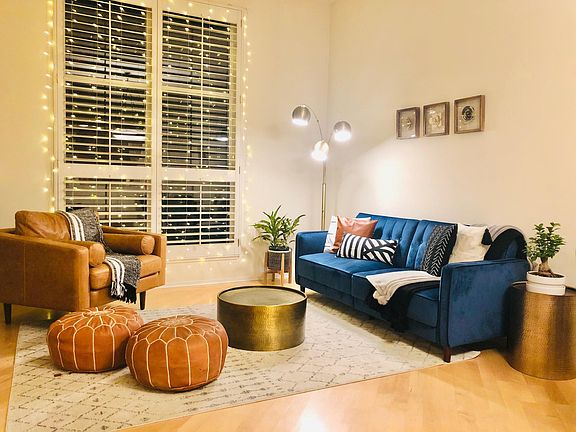 Large Living Room with High Ceilings, Hardwood Floors and Wood Shutters