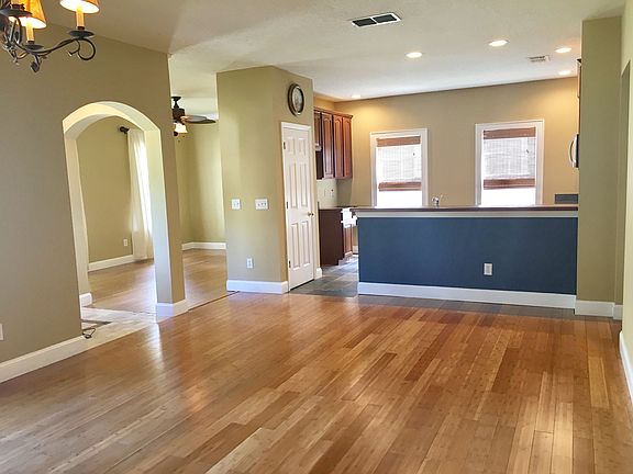 Living room with French doors onto front patio. Kitchen feat