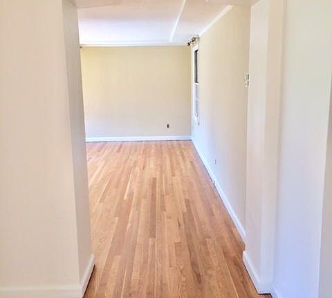 View of entry into living room from foyer with architectural