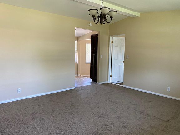 Living room with entrance to kitchen, dining room and garage addition.