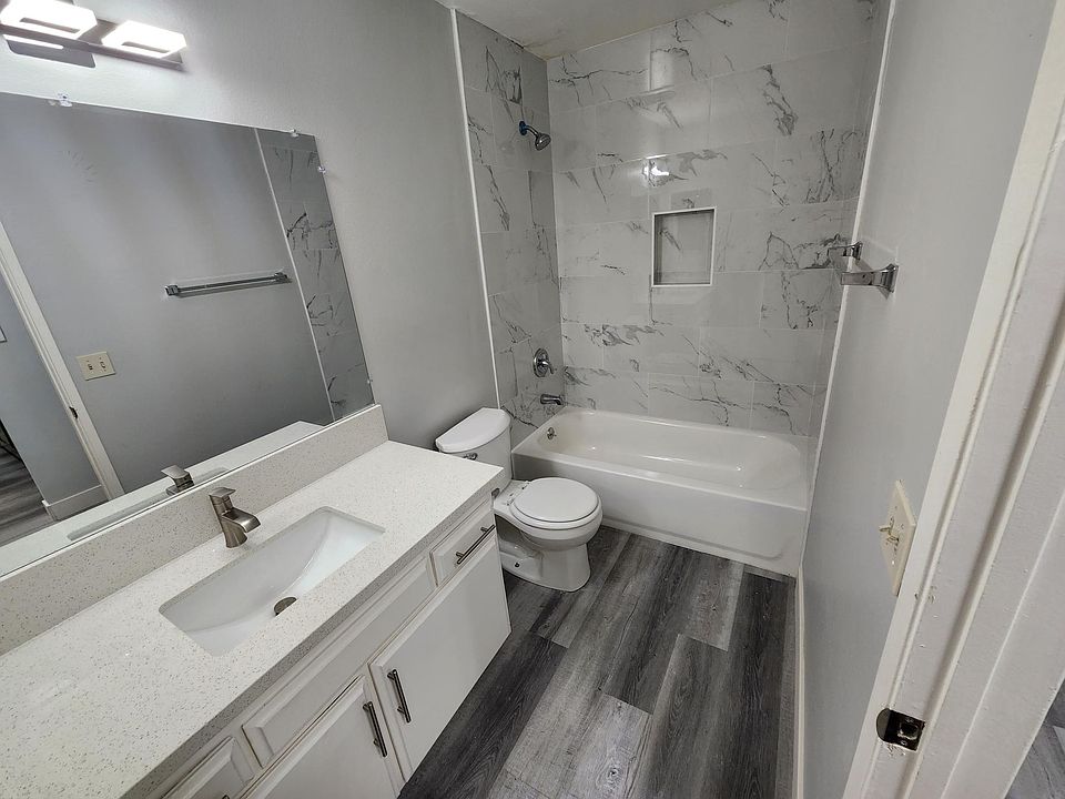 Newly renovated bathroom with laminate flooring and tiles