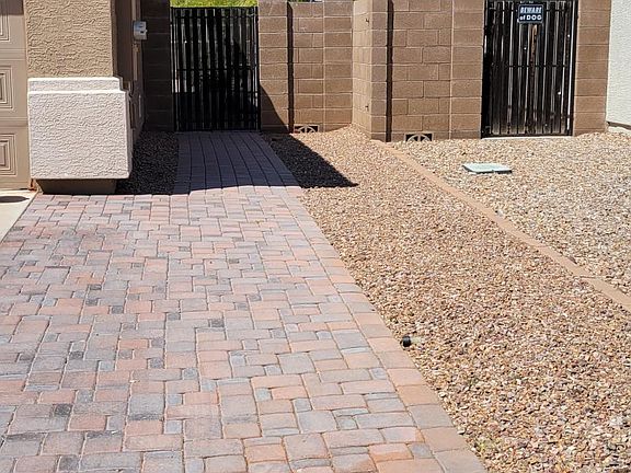 Pavers along the side of house for easy access to trash and recycle bins