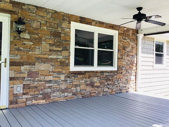 Close up view of the front porch to show the beautiful stack stone work and the ceiling fan.
